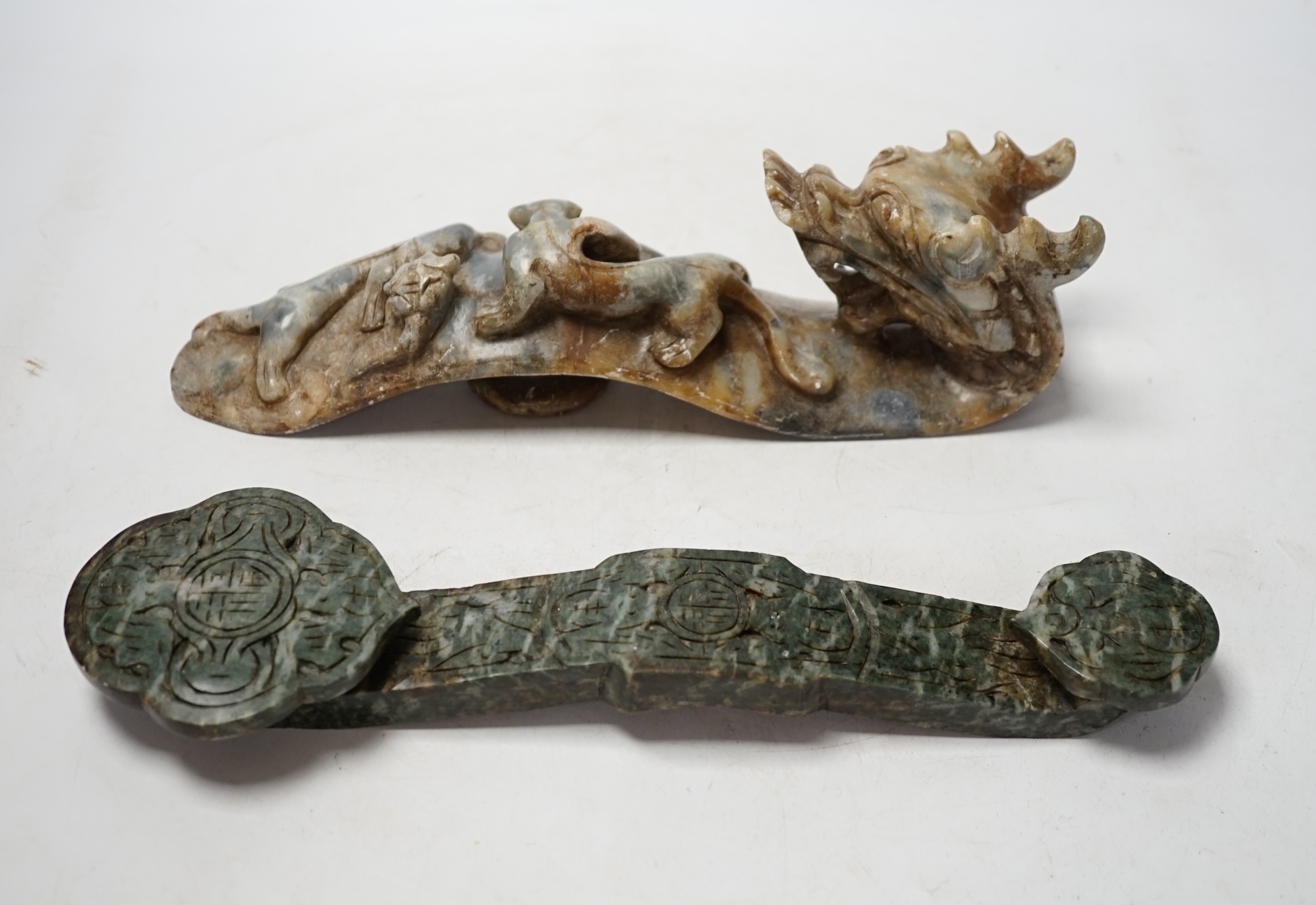 Two Chinese hardstone ruyi sceptres, one carved as a dragon, longest 30cm. Condition - fair